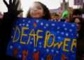 A Stricken Environment Thanking its Tormentor: Banners of Subjugation in a Deaf Nation.